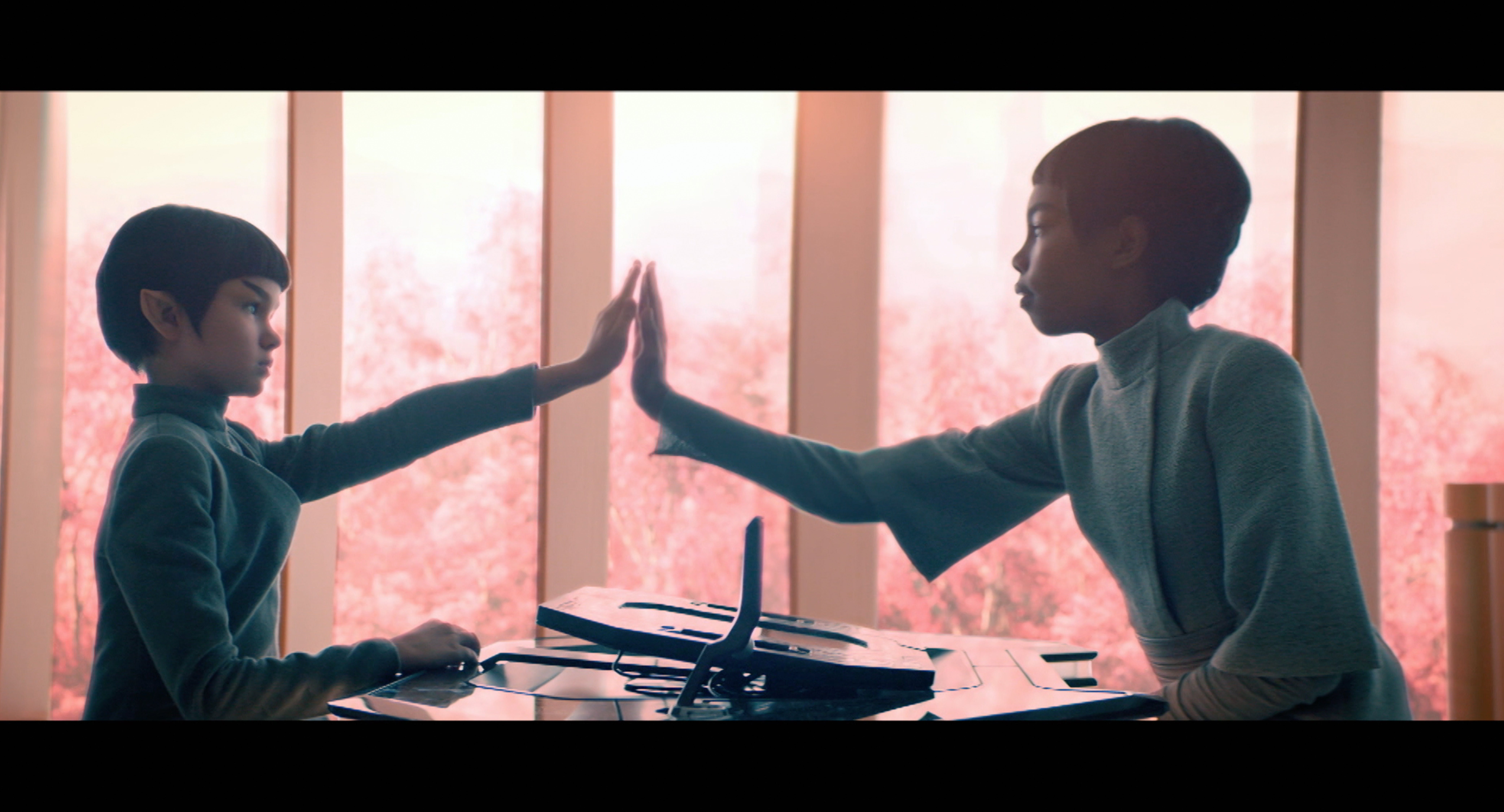 Still of young Spock and Michael Burnham from Star Trek: Discovery learning the Vulcan salute