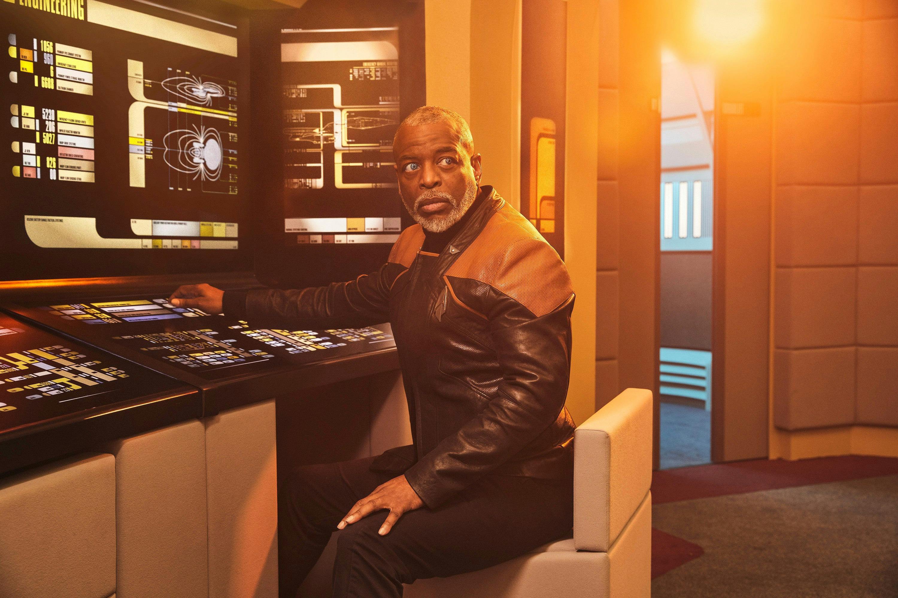 Geordi La Forge sits on the bridge of the reconstructed Enterprise-D