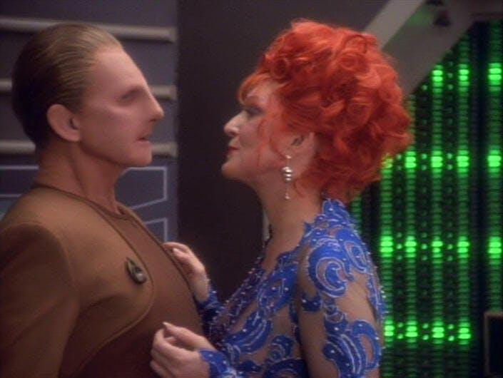 Lwaxana Troi aggressively flirts with an uncomfortable Odo who leans back in 'The Forsaken'