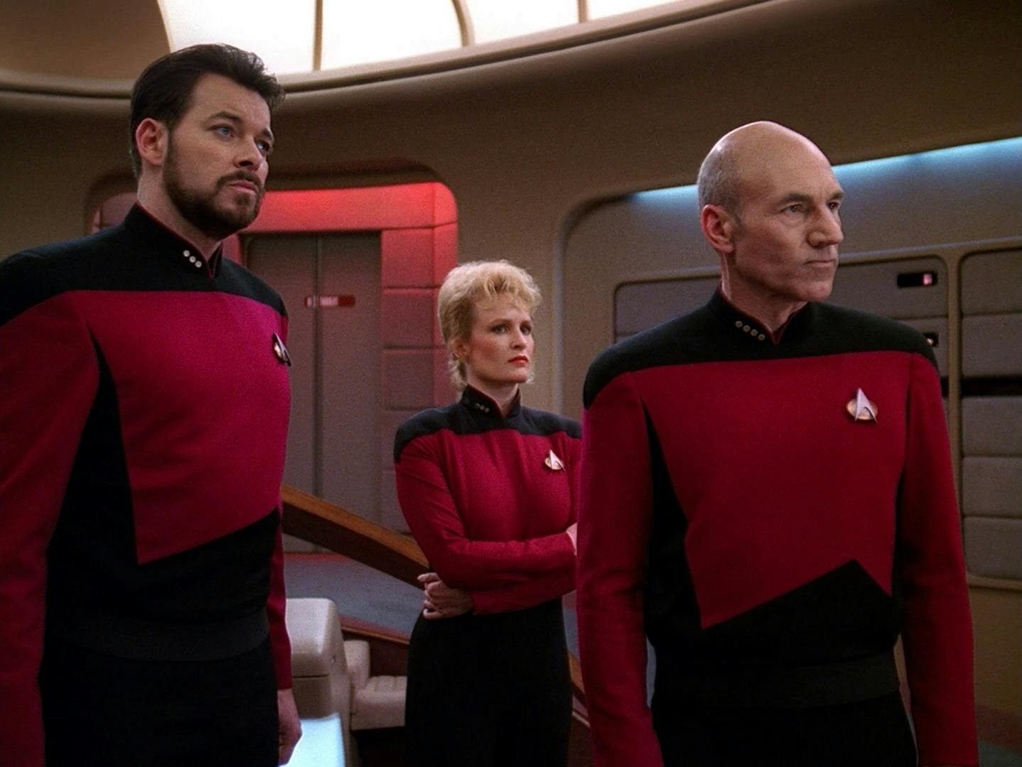 Will Riker and Jean-Luc Picard stand and sternly look at the Enterprise viewscreen ahead of them as Elizabeth Shelby wraps her arms around her and looks ahead in 'The Best of Both Worlds, Part I'