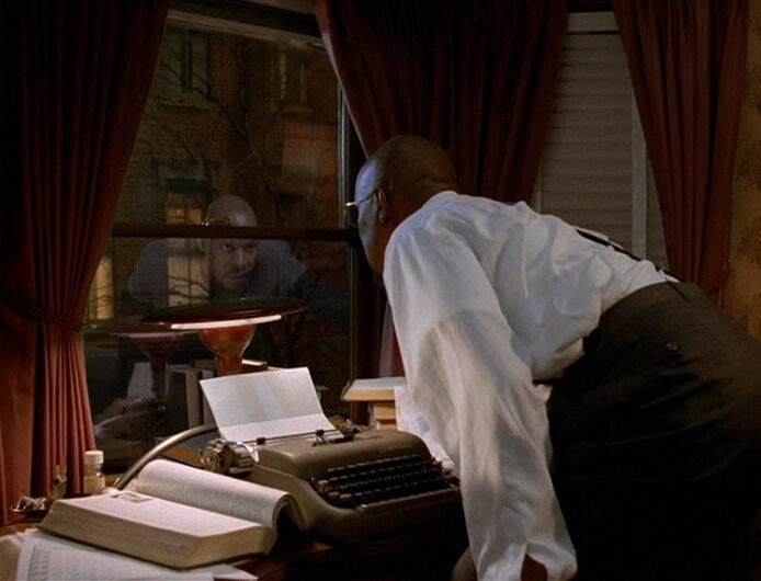 In his apartment hunched over his typewriter, Benny Russell looks out his 1950s NYC apartment window and sees the reflection of Captain Sisko looking back at him in 'Far Beyond the Stars'