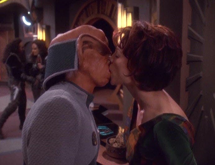 On the Promenade, Rom and Leeta embrace in 'Ferengi Love Songs'