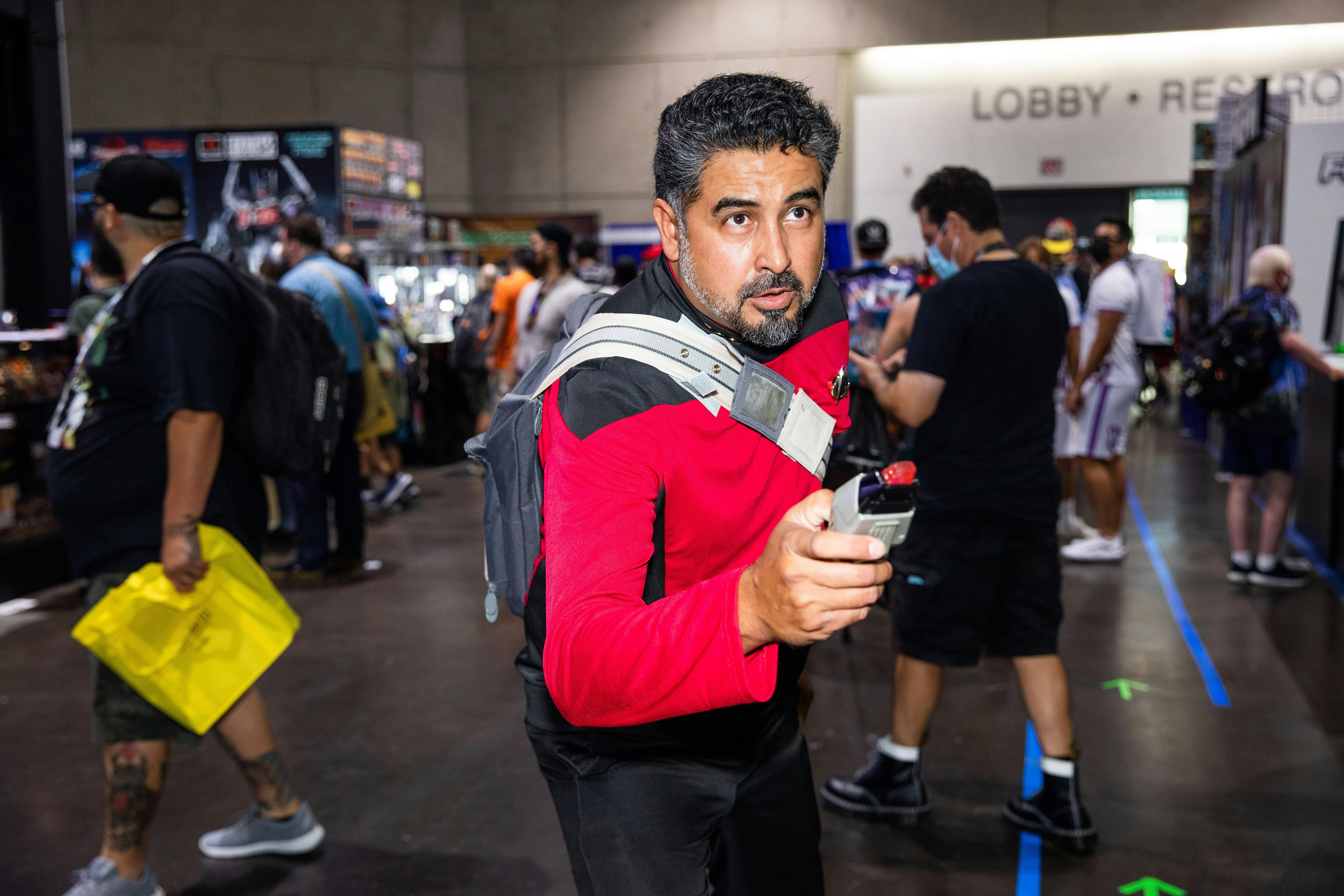 A cosplayer is ready for action as he poses with a phaser.