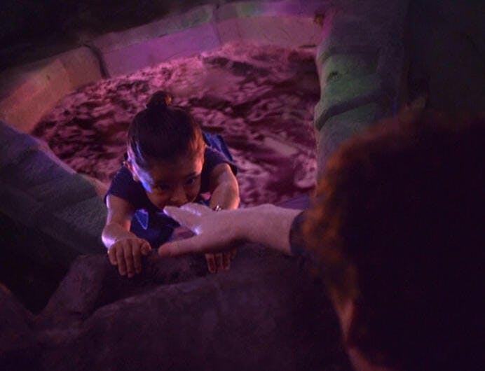 Molly O'Brien falls through a time portal as her parents try to grab her before she falls in 'Time's Orphan'