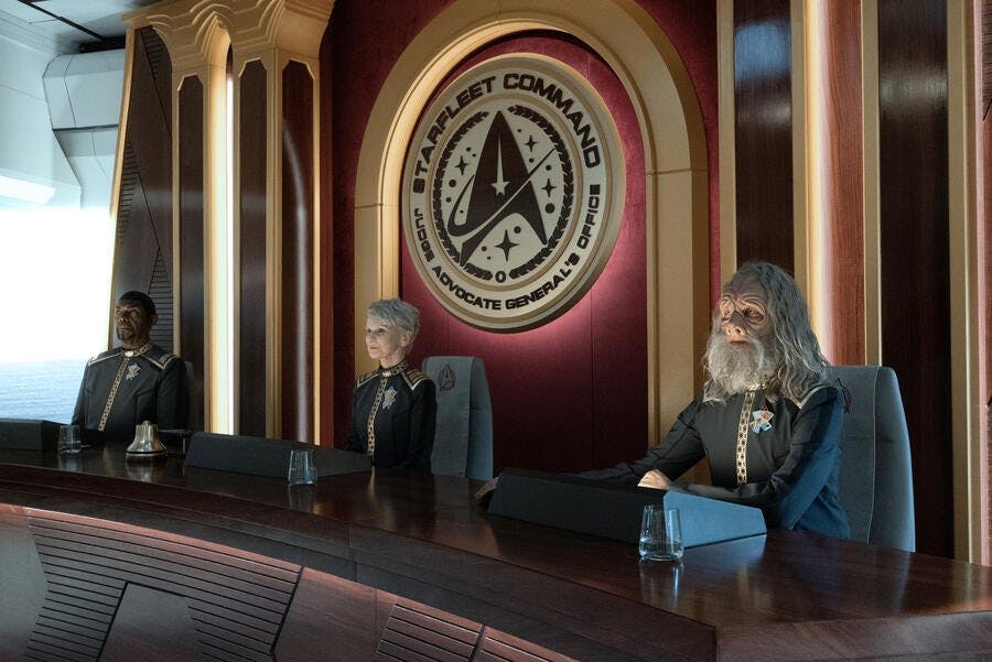At Starfleet Headquarters, Admiral Javas sits on the dais with a Vulcan judge and Tellarite judge in 'Ad Astra per Aspera'