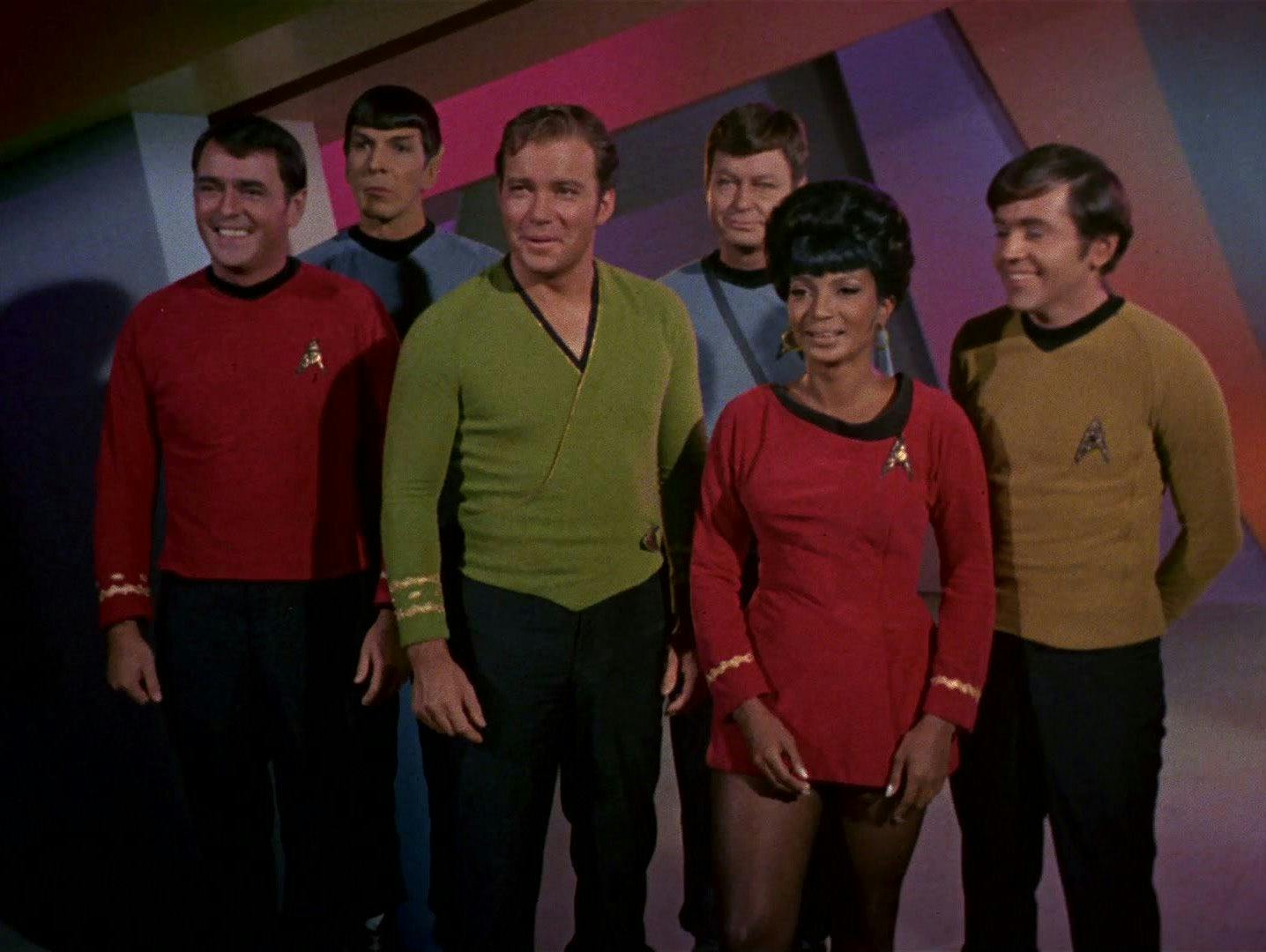 Captain Kirk (The Original Series) and his crew smile at the end of an episode.