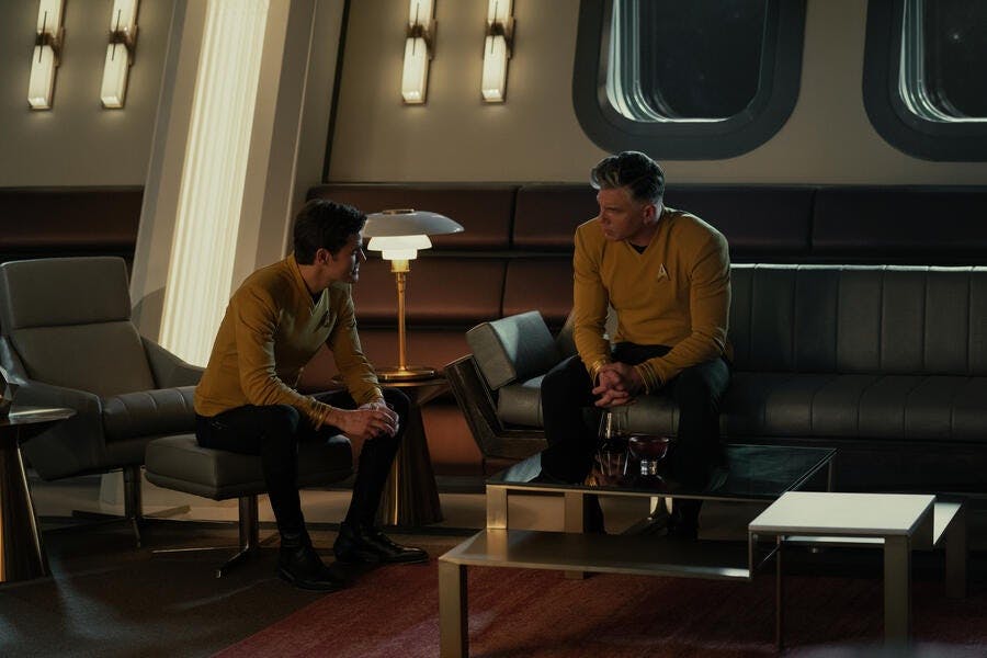 James Kirk (Paul Wesley) sits in conference with Captain Pike (Anson Mount) in Pike's ready room.