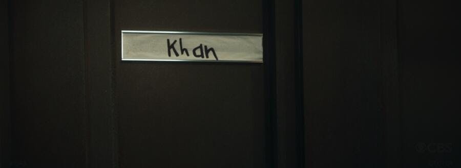 A door with a child's handwritten label that says 'Khan' in 'Tomorrow and Tomorrow and Tomorrow'