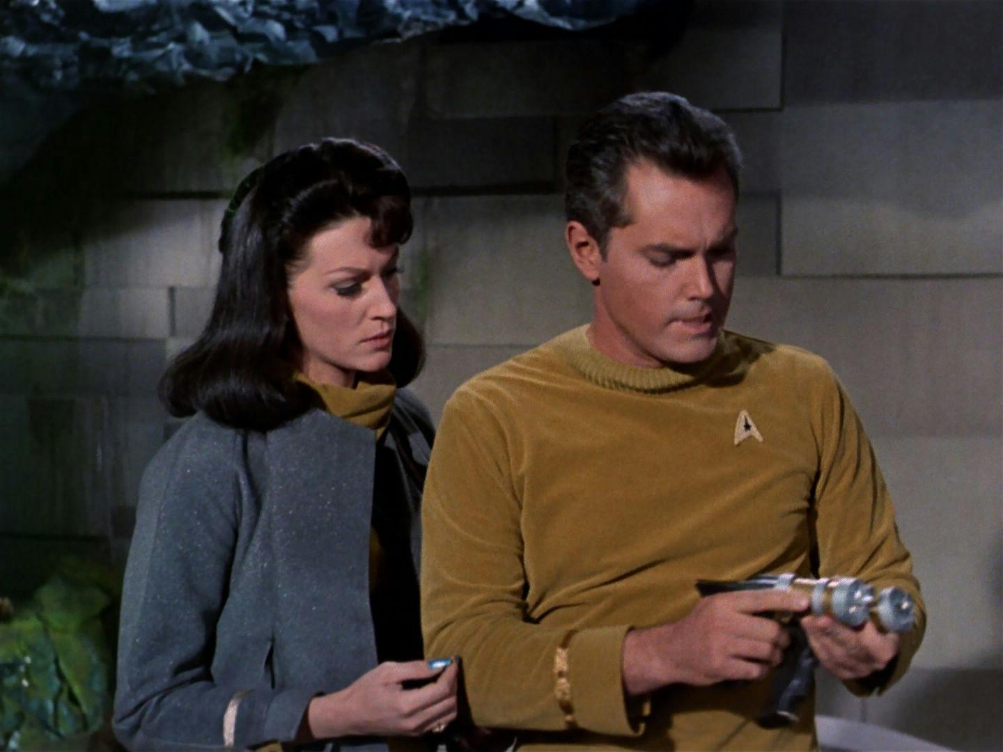 Captain Pike holds a phaser
