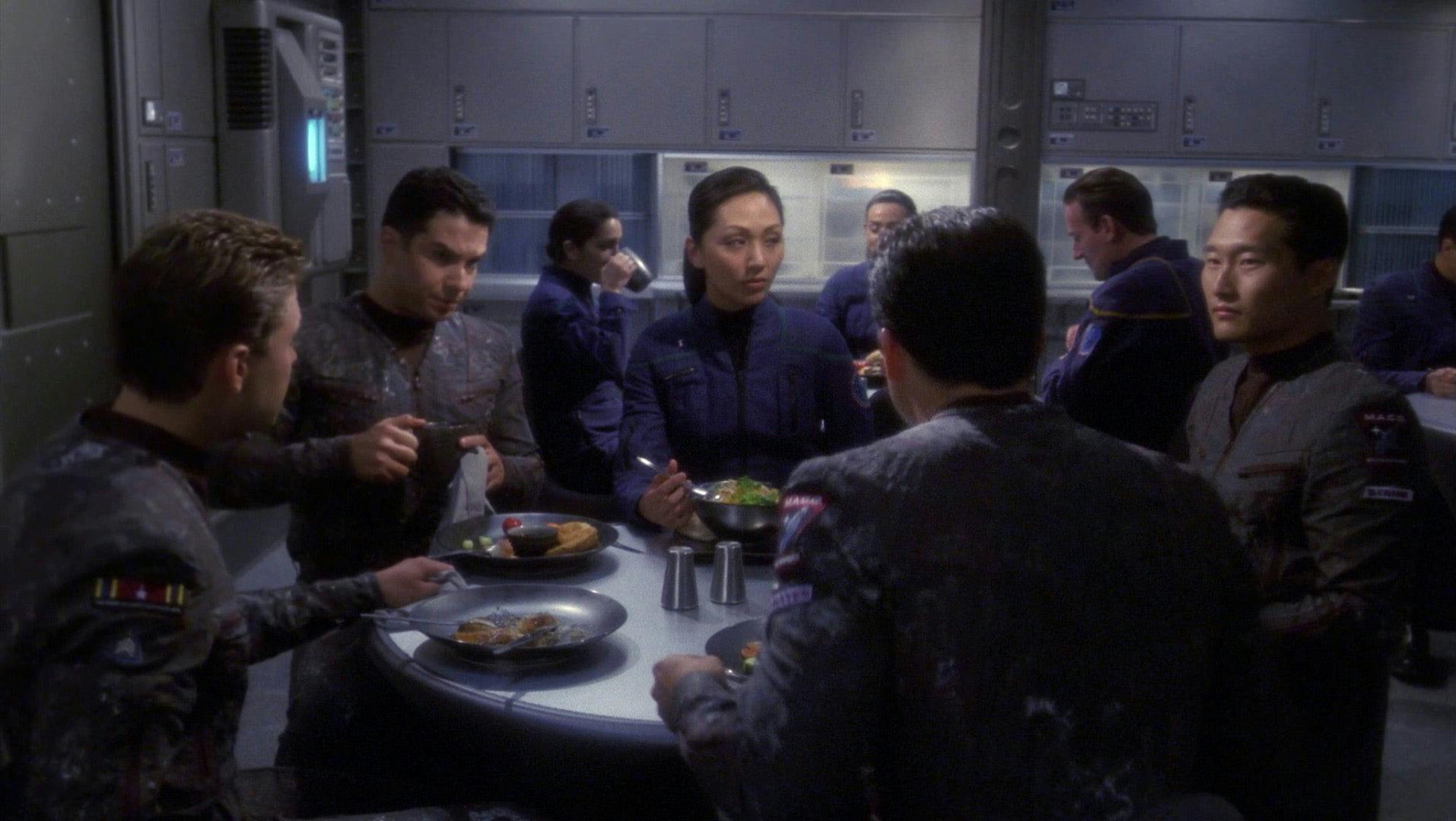 MACO soldiers sit around a table eating a meal in the Enterprise mess hall on Star Trek: Enterprise