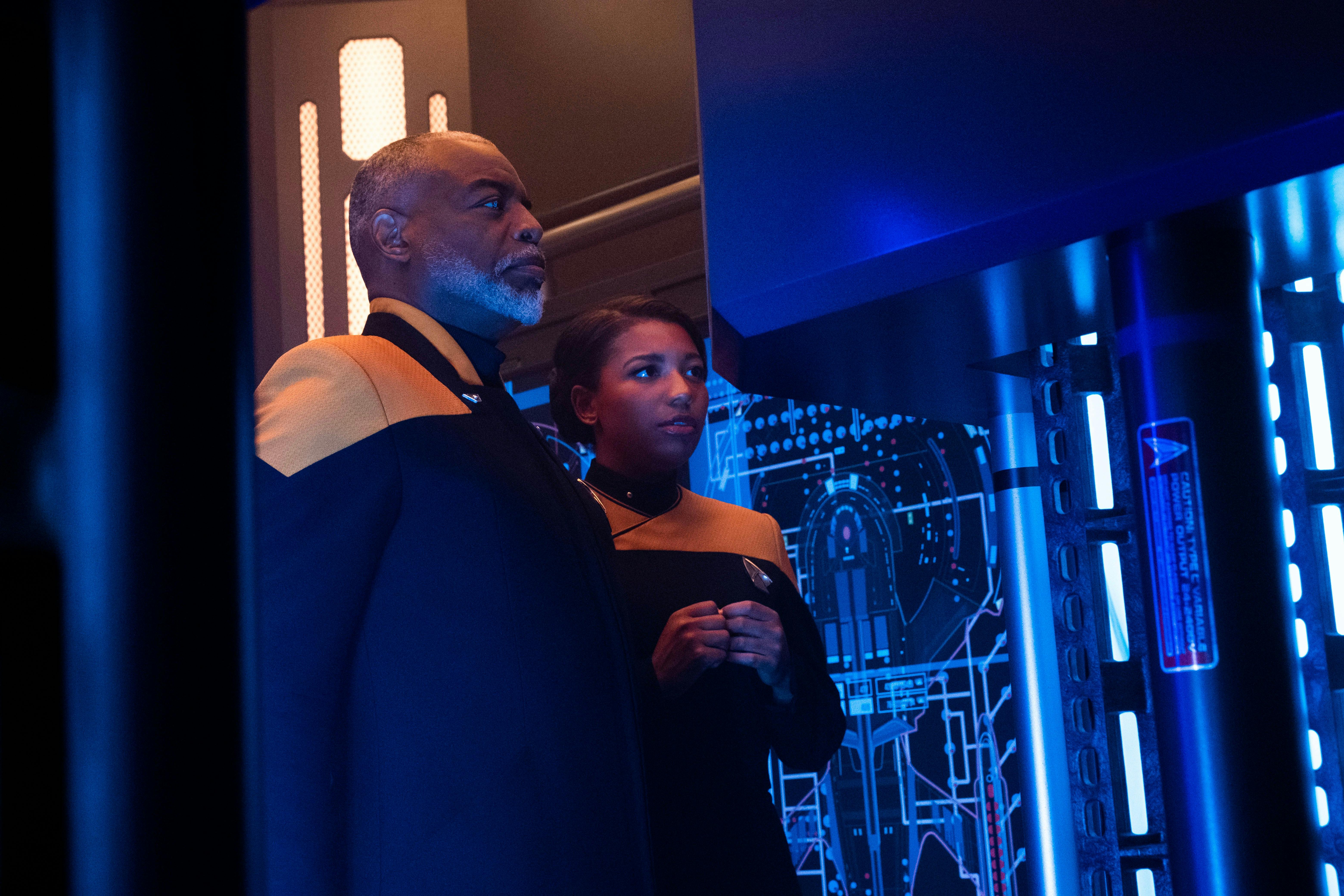 Geordi and Alandra La Forge stand side by side in Engineering of the Titan
