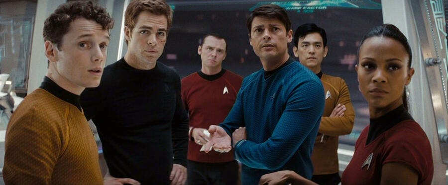 Chekov, Jim Kirk, Scotty, Bones, Sulu, and Uhura standing together looking ahead towards Spock in Star Trek (2009)