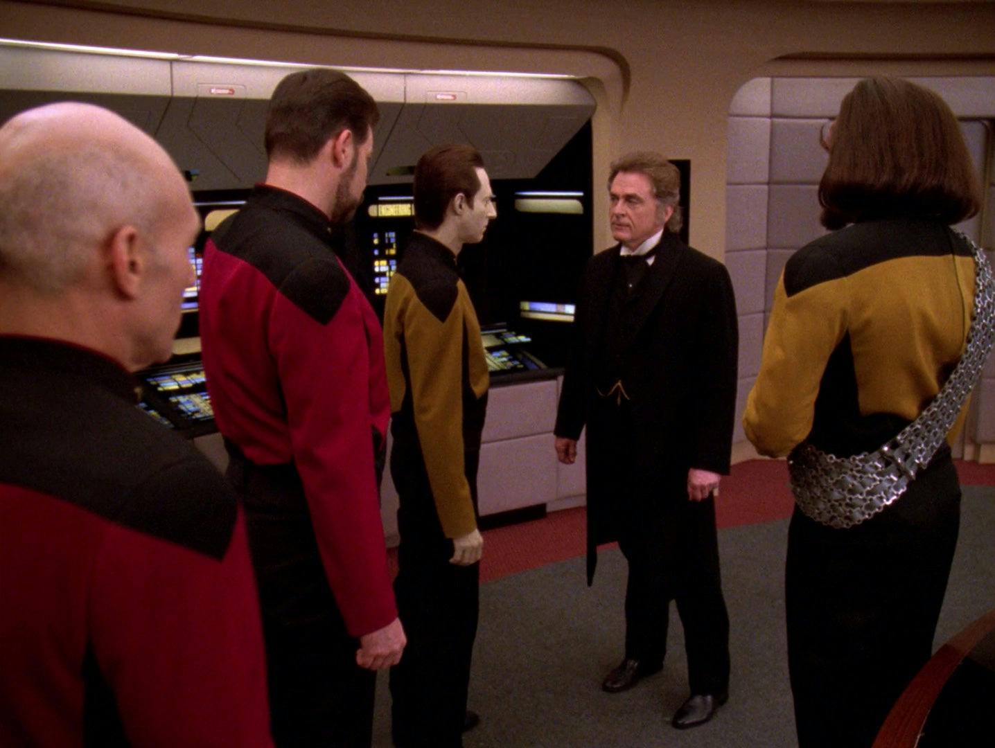 Moriarty stands on the bridge of the Enterprise-D facing Data, Riker, Picard, and Worf