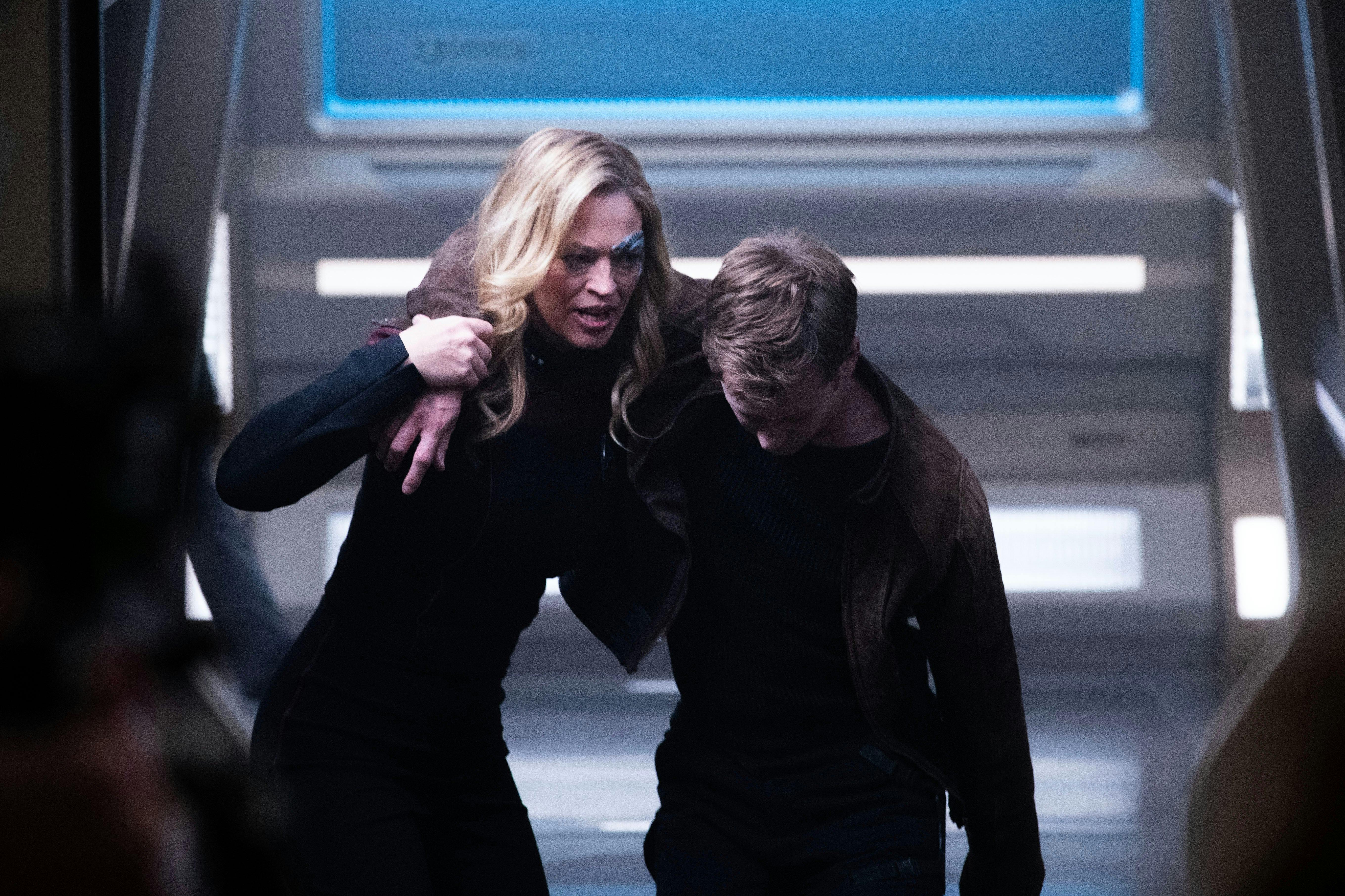 Seven of Nine carries an unconscious and poisoned Jack Crusher towards Sickbay on Star Trek: Picard