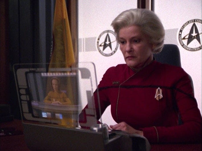 The future Admiral Janeway looks at her viewscreen monitor