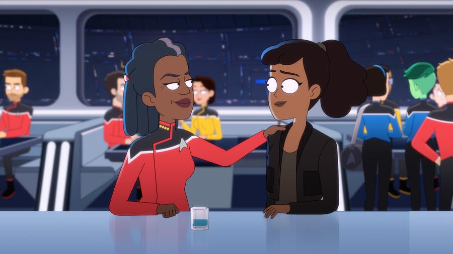 In the crowded Cerritos mess hall, Freeman proudly puts her hand on Mariner's shoulder on Star Trek: Lower Decks