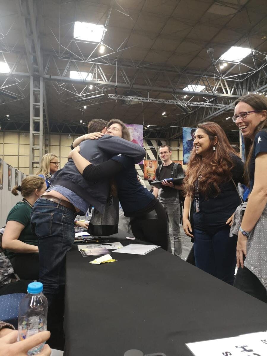 Jason Isaacs and Steffi Hochriegl share a friendly embrace.