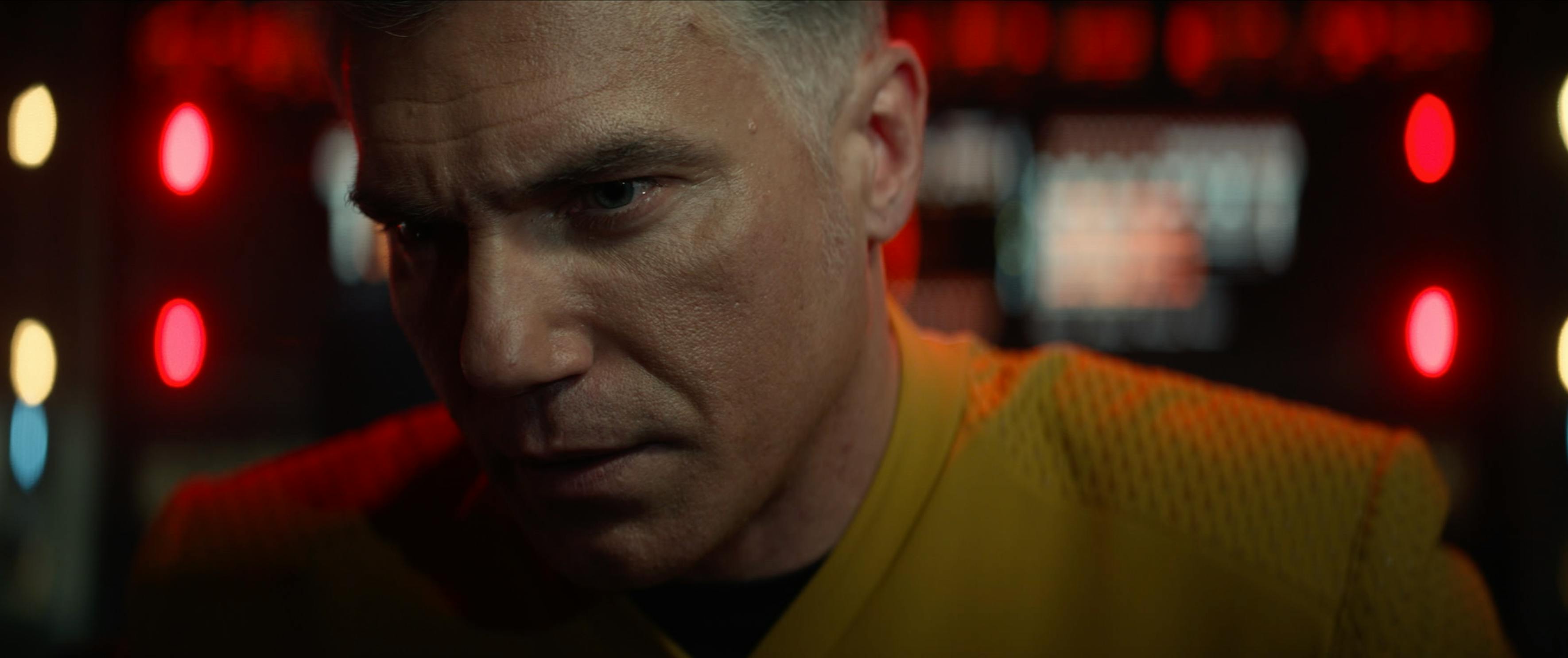 Captain Pike (Anson Mount) is in extreme close up, looking worried.