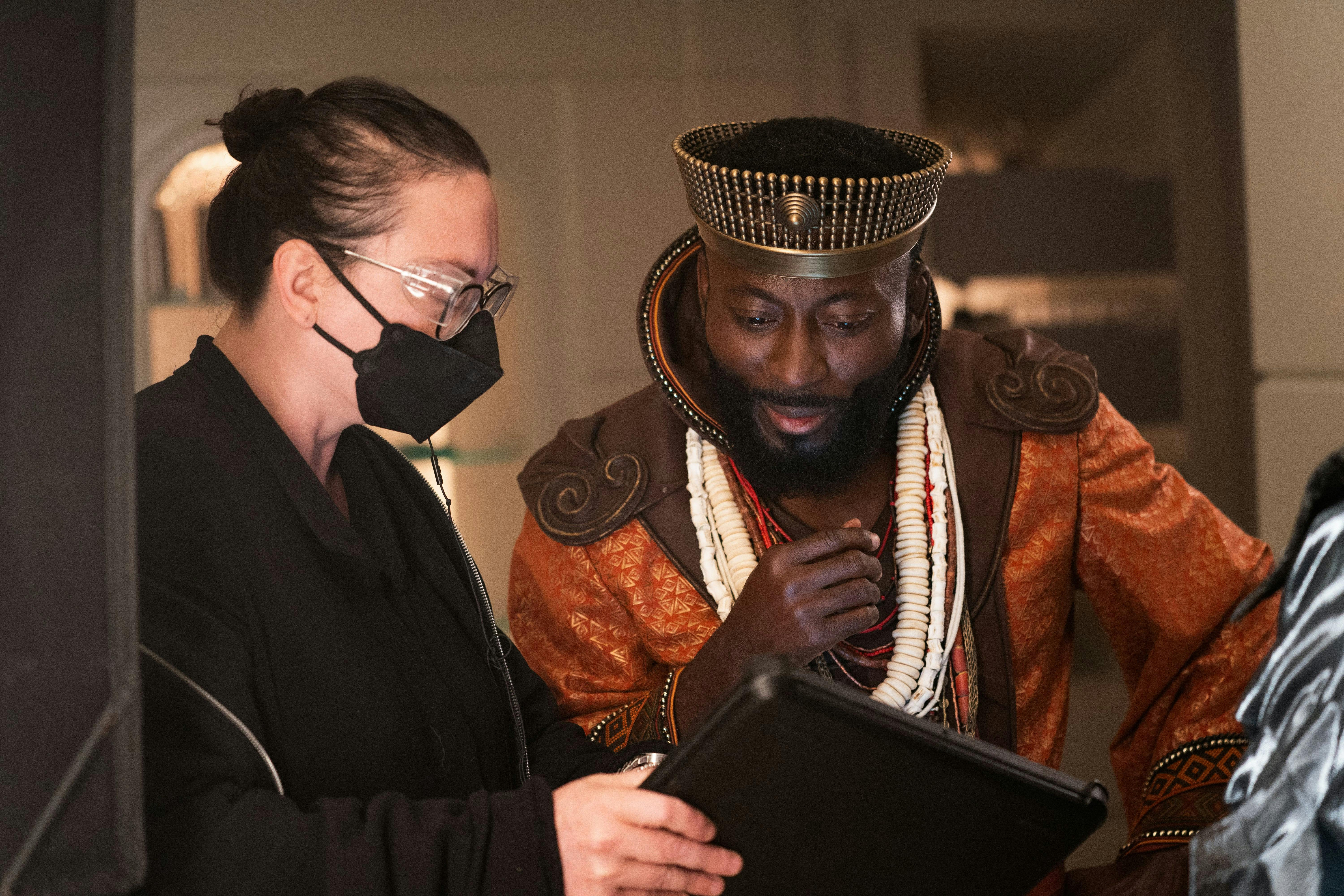 Babs Olusanmokun reviews the script for "The Elysian Kingdom," dressed as King Ridley.