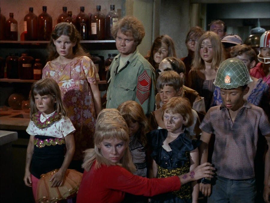 Miri stands besides Jahn, leader of the Onlies, and the captive Janice Rand