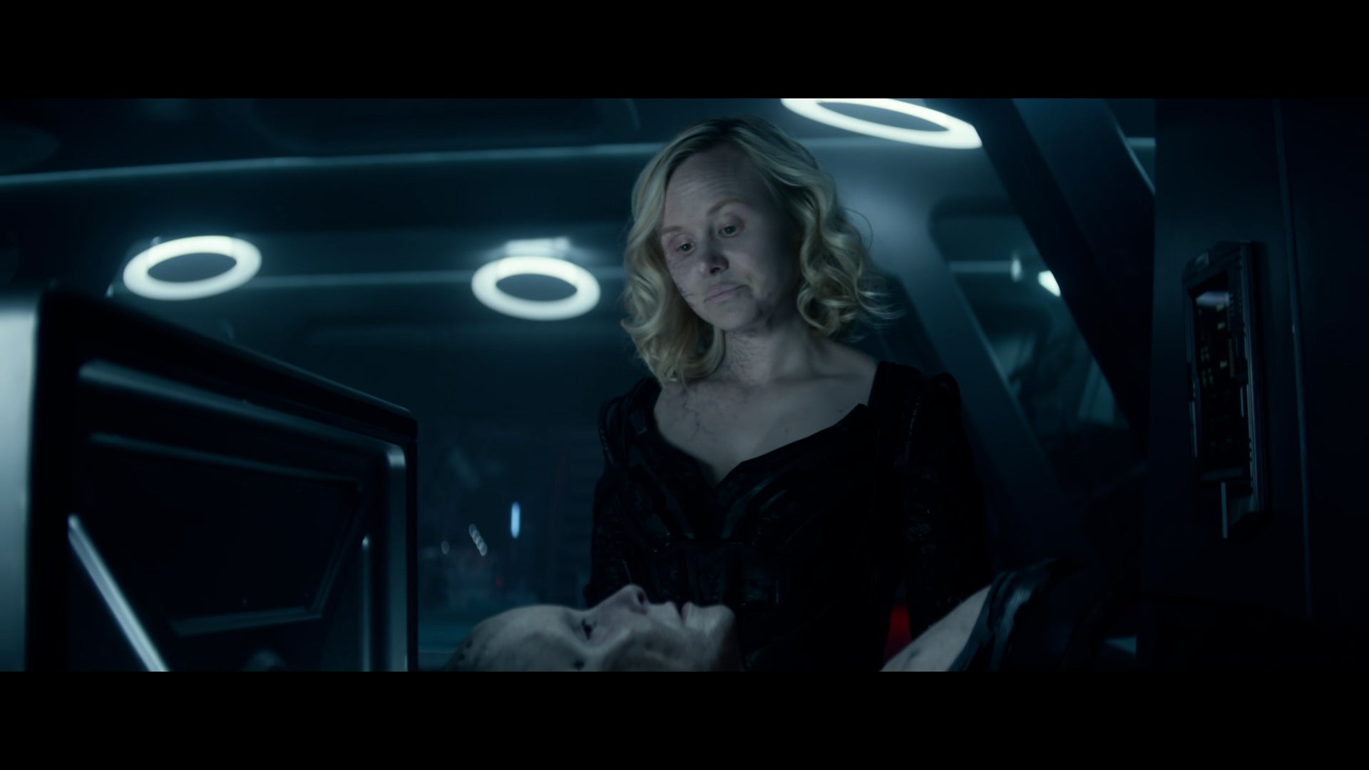 Jurati standing over the Borg Queen, wearing the Queen's outfit. 