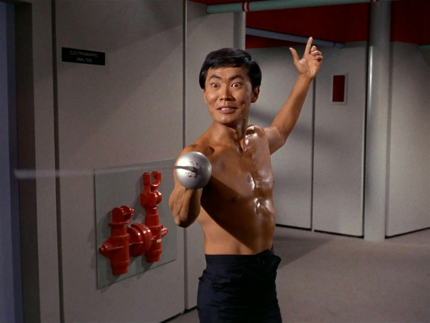 A shirtless Sulu brandishes a fencing sword