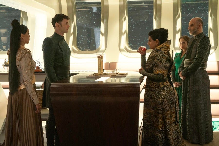 Across from T'Pring and Spock stands T'Pril, Sevet, and Amanda Grayson during the young couple's Vulcan engagement dinner as T'Pring's mother judges Spock's preparation of ritual tea in 'Charades'