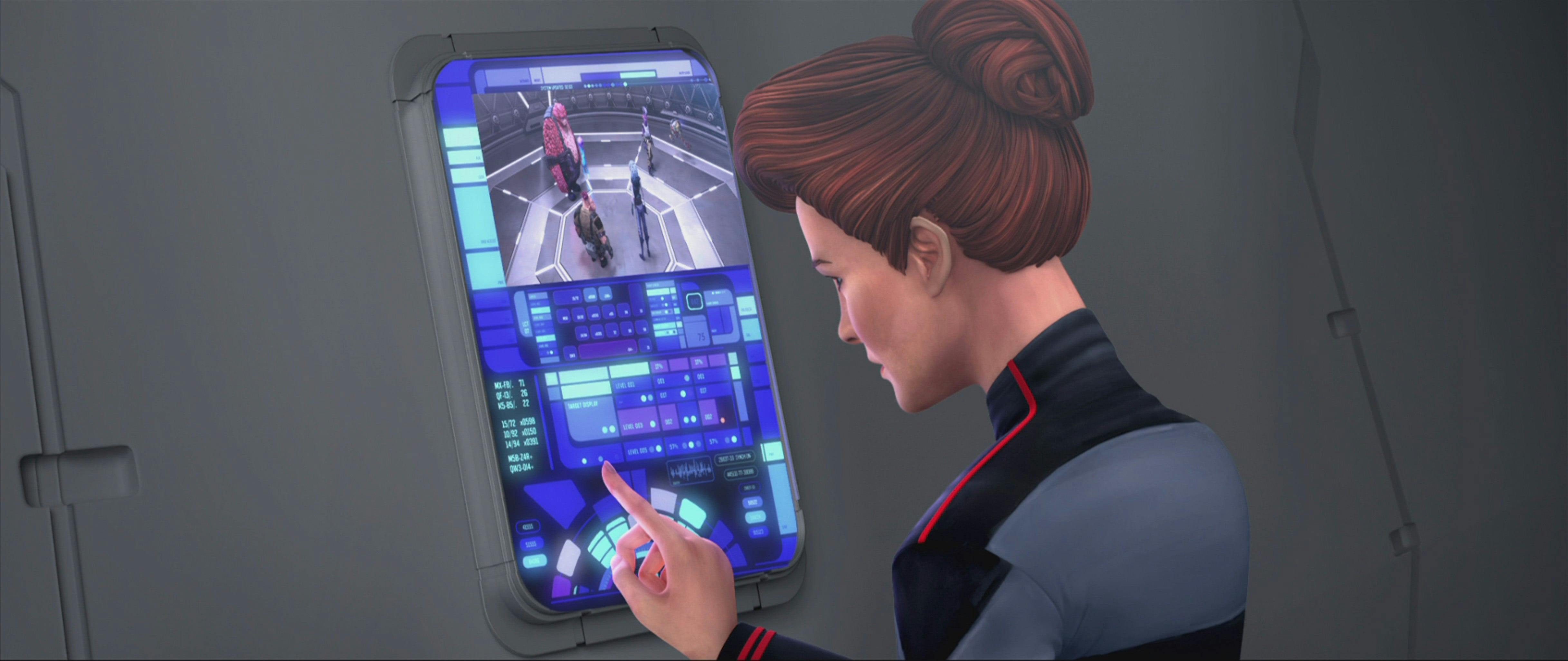 Hologram Janeway looks at a monitor with Rok-Tahk, Jankom Pog, Murf, Gwyn, Dal, and Zero on-screen on Star Trek: Prodigy
