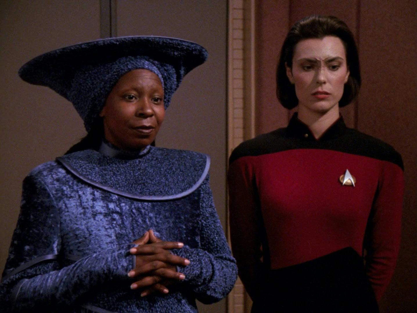 Guinan and Ro Laren stand side-by-side in Captain Picard's ready room in 'Ensign Ro'