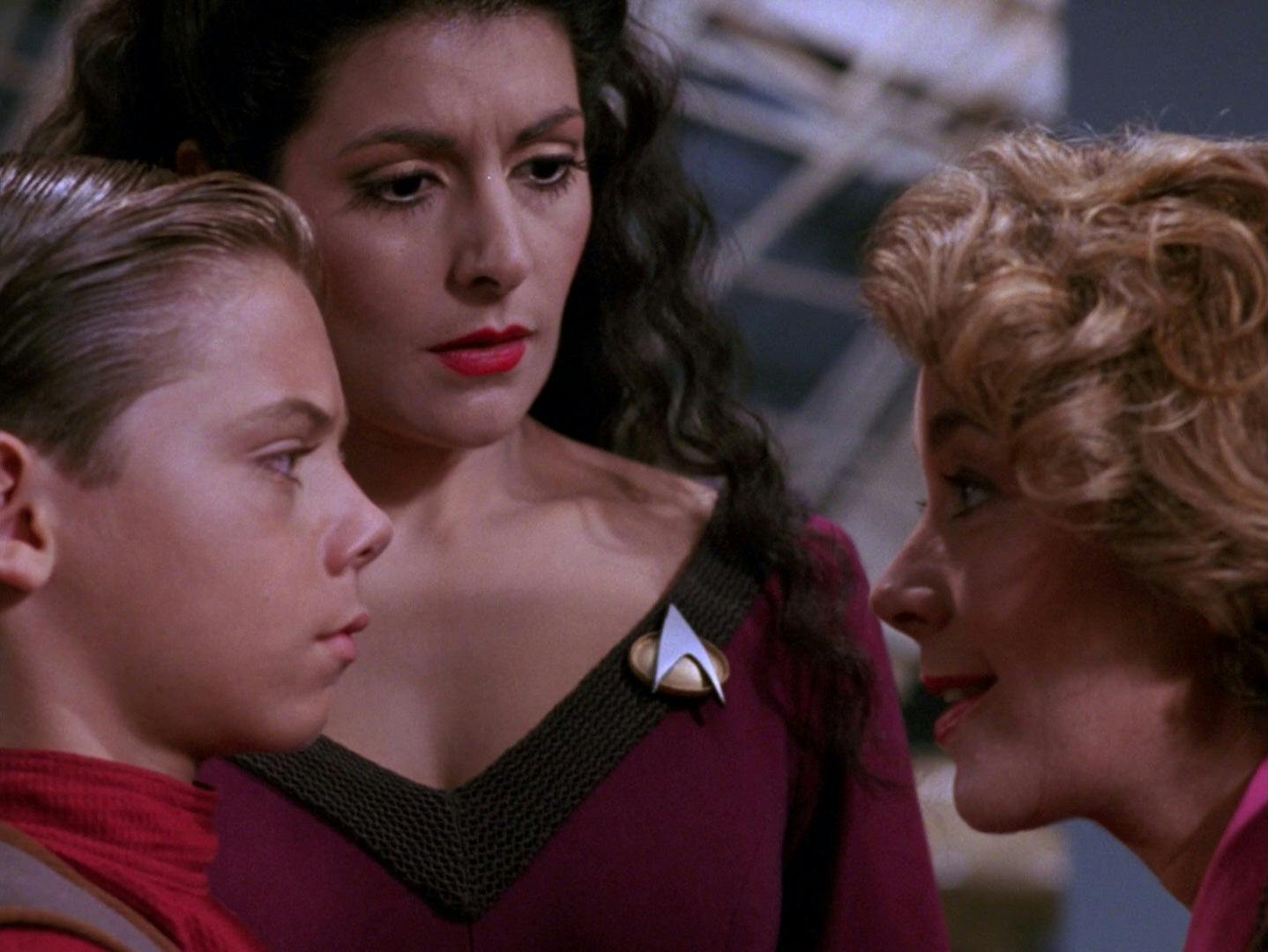 An alien inhabiting the form of the late Marla Aster tries to convince Jeremy that she's his real mother as Deanna Troi is curious about the situation in 'The Bonding'