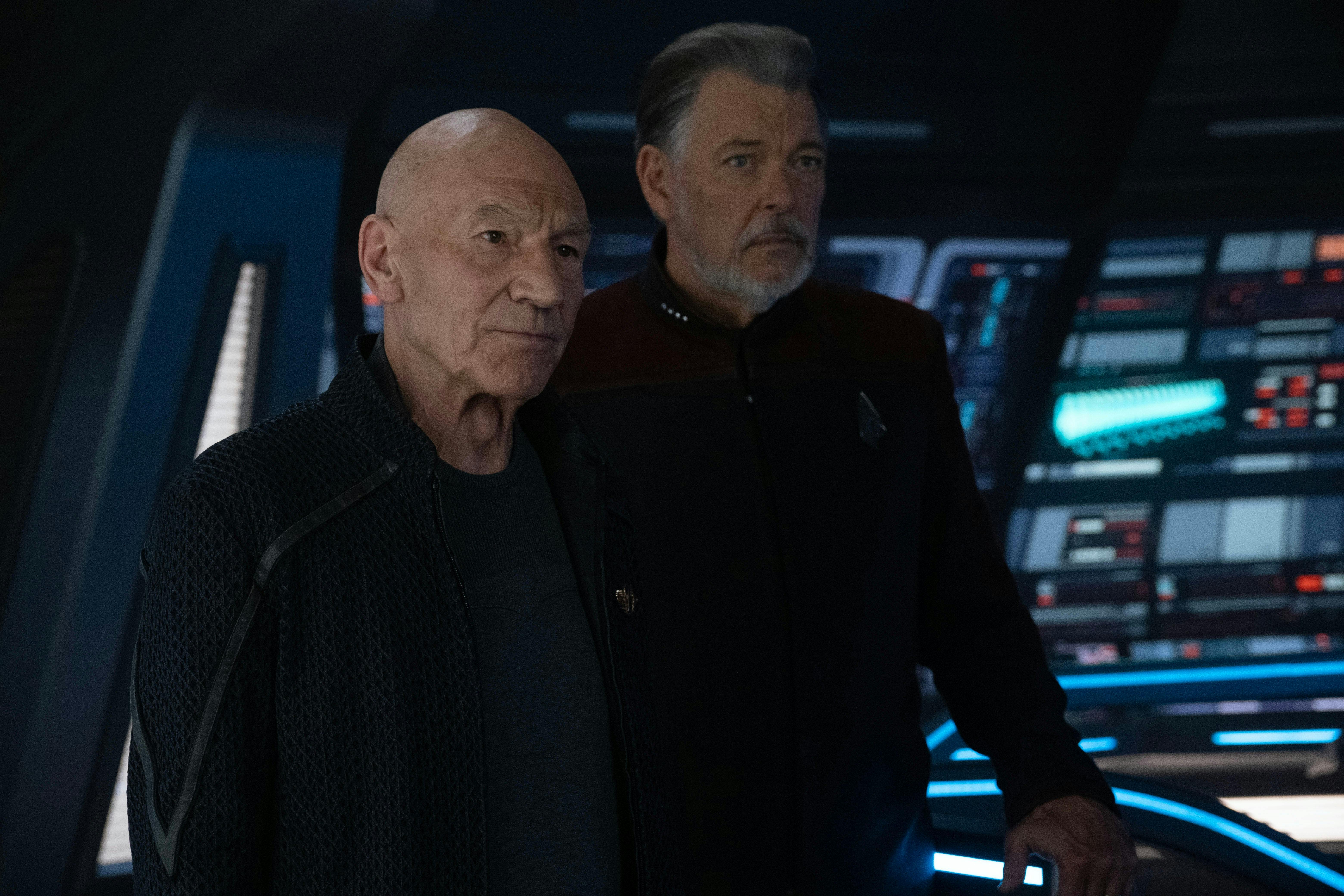 Admiral Picard and Captain Riker look ahead while on the bridge of the Titan on Star Trek: Picard