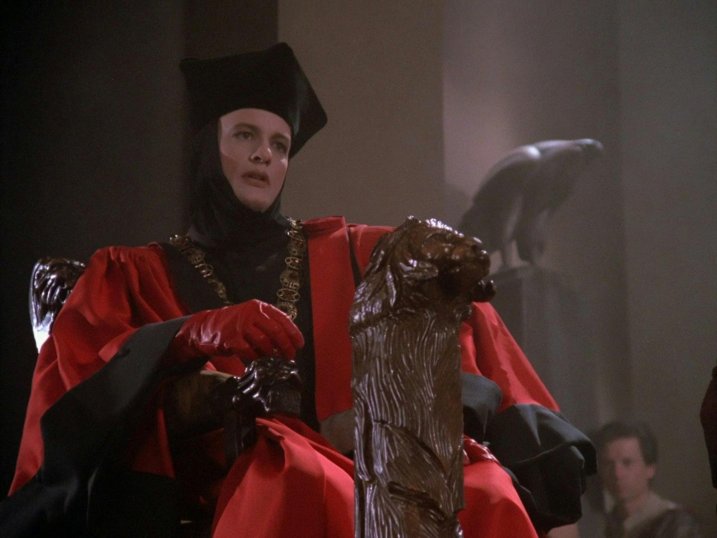 Q, wearing his judge's robe, sits on his throne in 'Encounter at Farpoint, Part I'