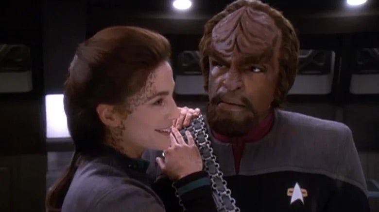 Jadzia Dax rests her hands on Worf's shoulders on Star Trek: Deep Space Nine