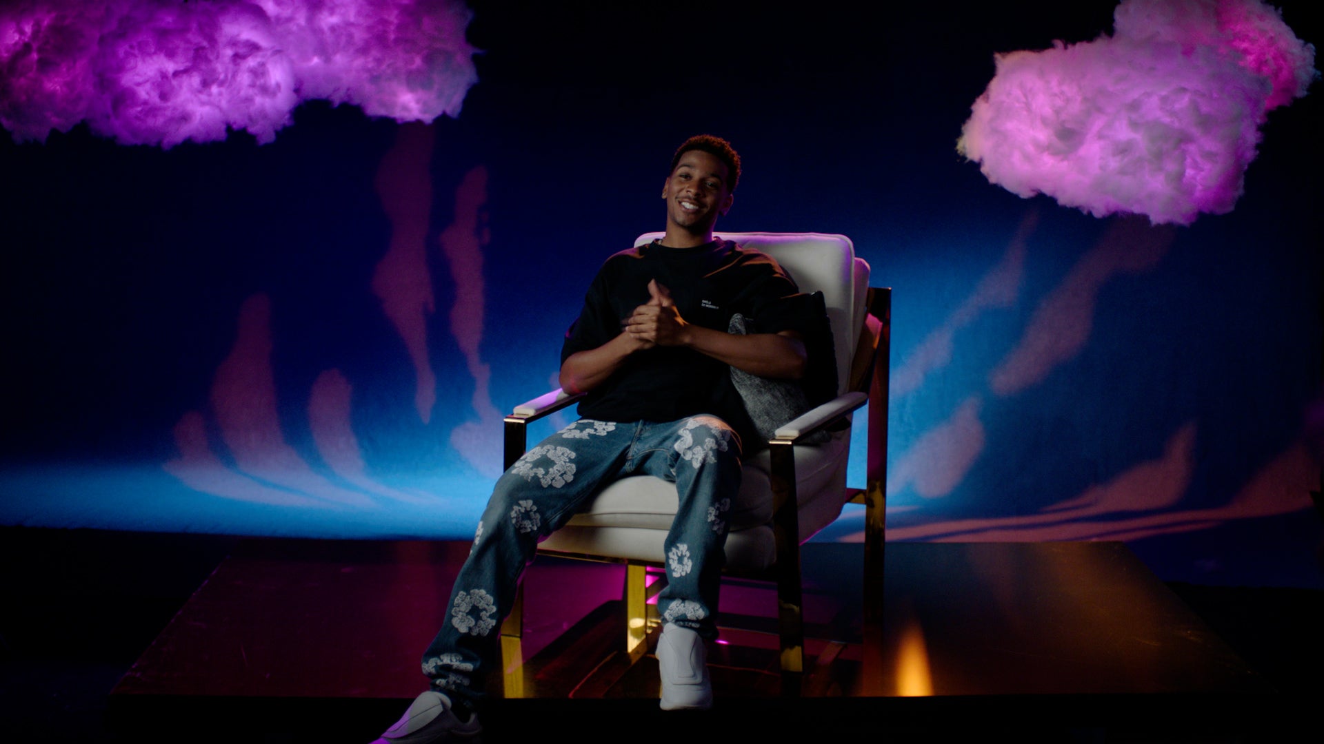 Star Trek: Prodigy's Brett Gray leans back in a chair and clasps his hands