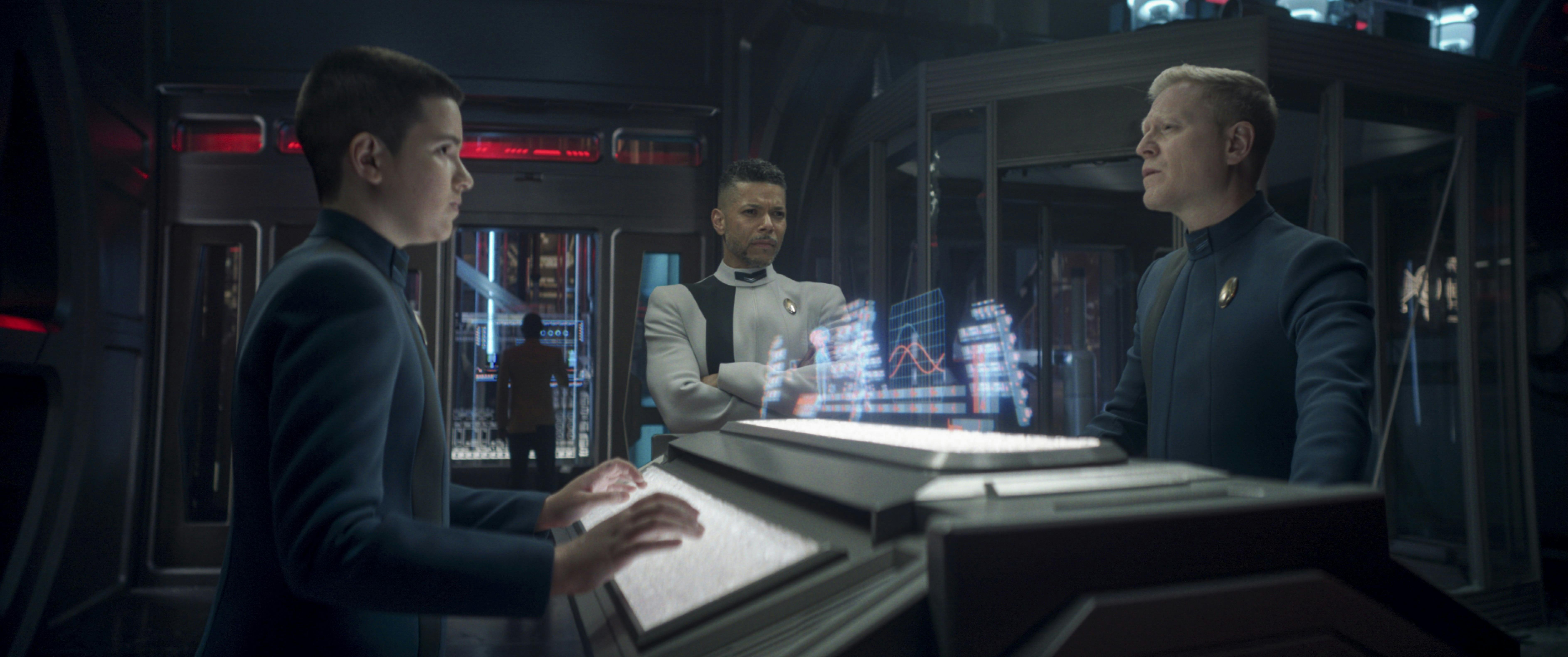 At their station in Engineering, Adira looks directly across at Stamets as Culber stands by in 'Coming Home'
