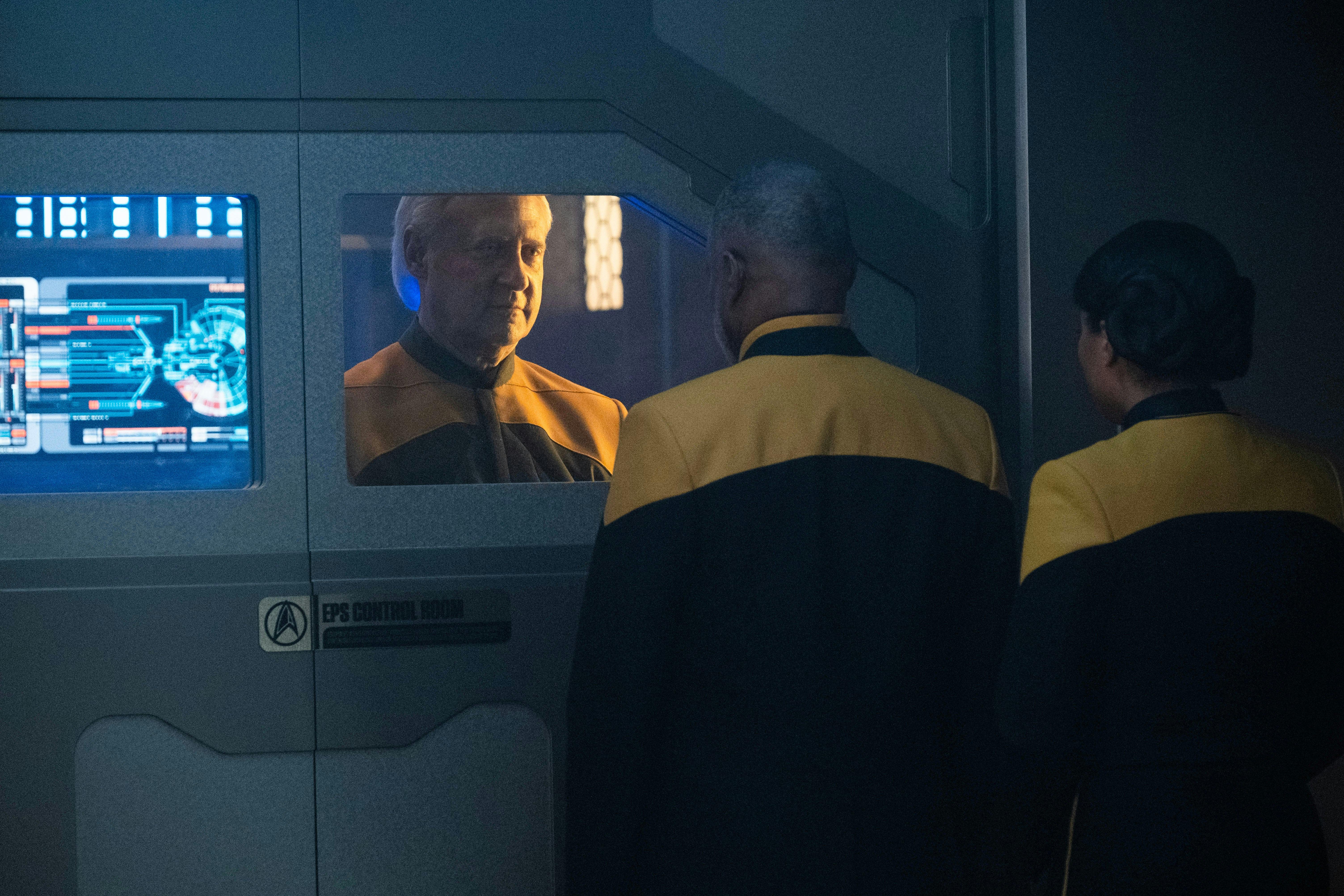 Lore behind the door of the EPS Control Room on the Titan smirking at Geordi and Alandra La Forge on the other side