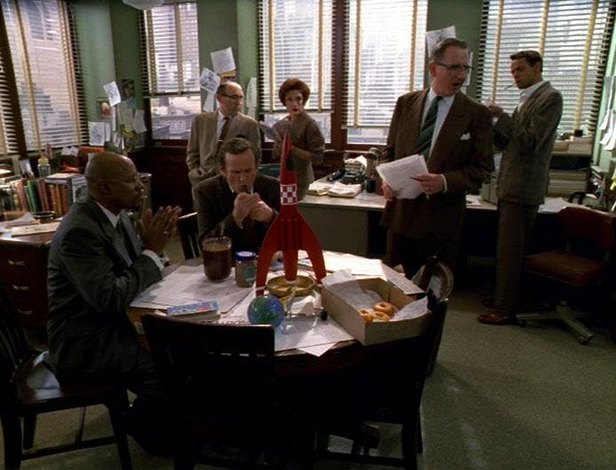 Benny Russell and his colleagues sit around the office common space with a model rocket ship and a box of donuts in Star Trek: Deep Space Nine 'Far Beyond the Stars'