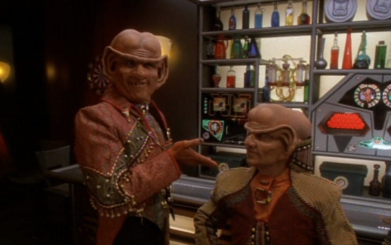 At Quark's, Brunt stands in front of the bar and directs everyone's attention to Leck in 'The Magnificent Ferengi'