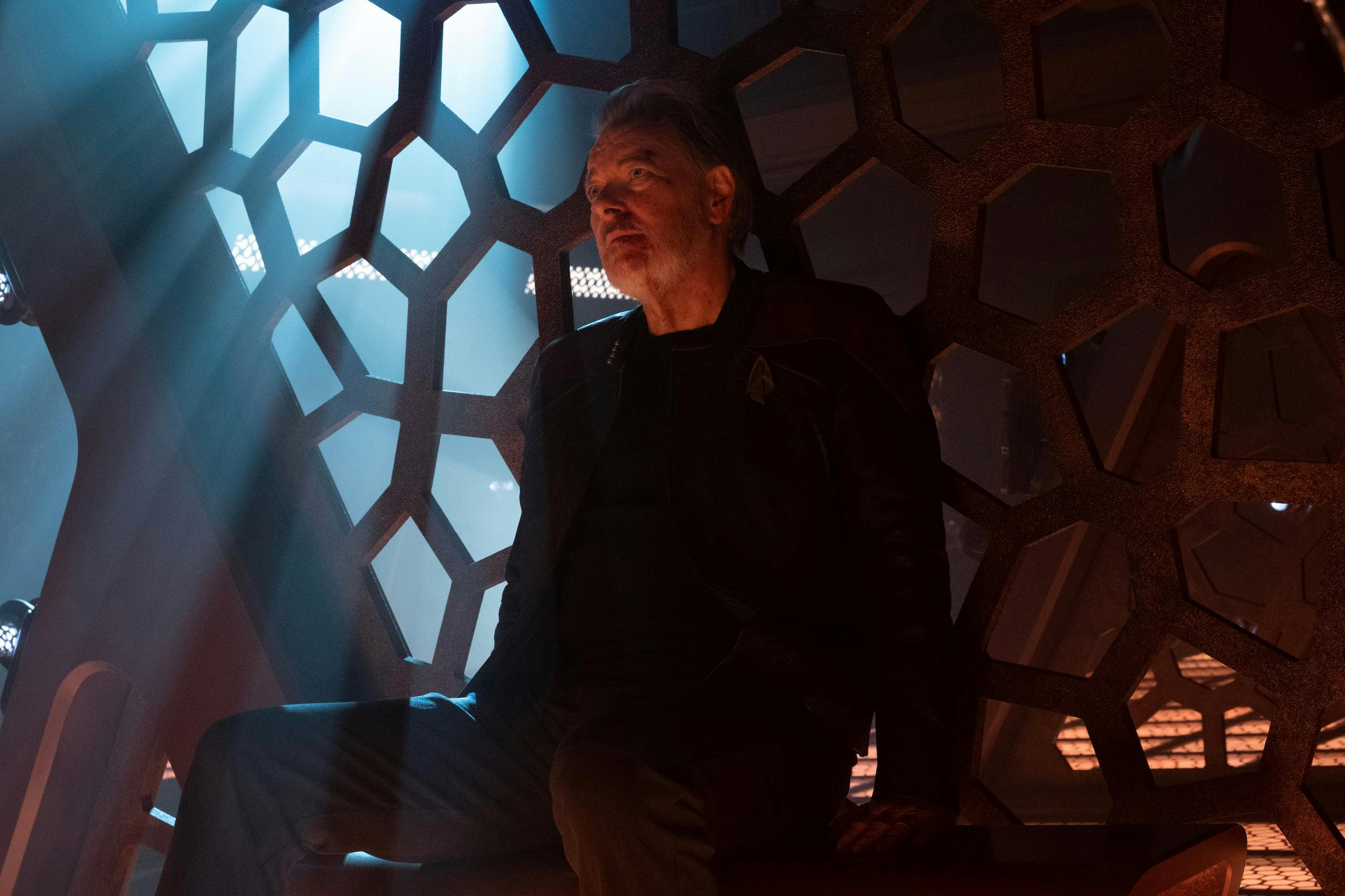 A beaten Will Riker sits in his cell aboard the Shrike