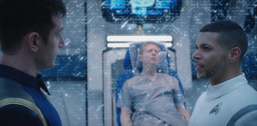 Gabriel Lorca and Dr. Hugh Culber face each other in Sickbay as Paul Stamets recovers in sickbed in 'Despite Yourself'