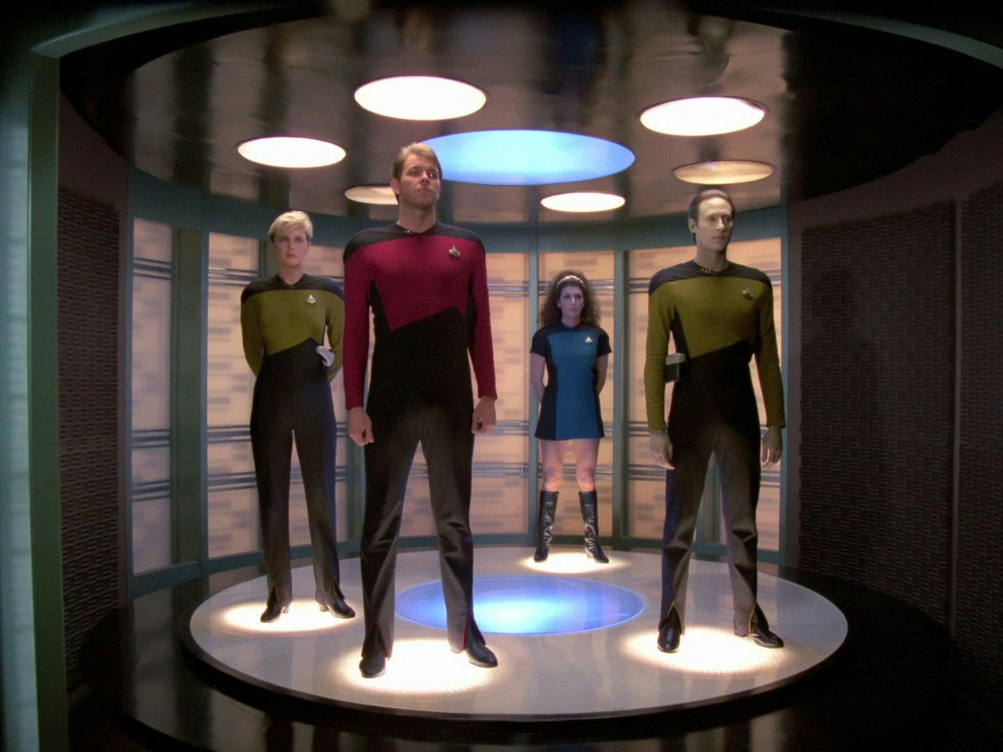 Tasha Yar, Will Riker, Deanna Troi, and Data all stand on the transporter pad in 'Encounter at Farpoint, Part II'