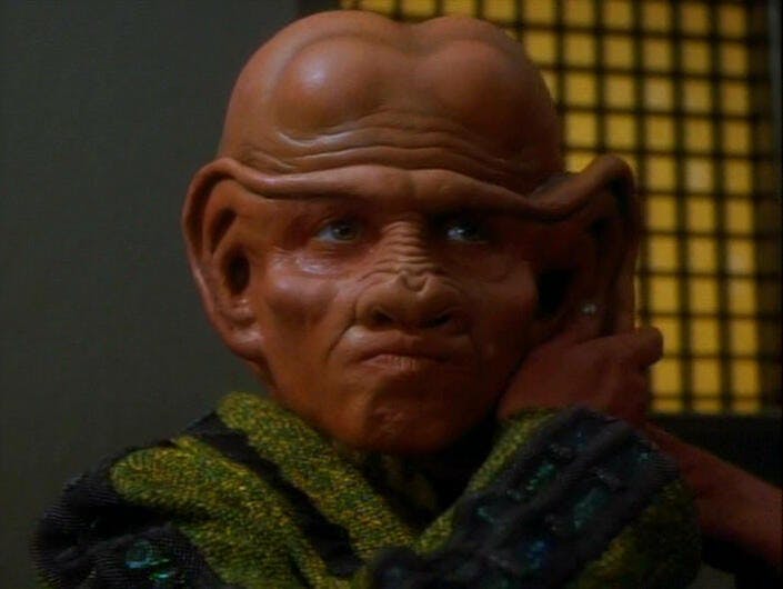 Pel removes one of her prosthetic male Ferengi ears in 'Rules of Acquisition'