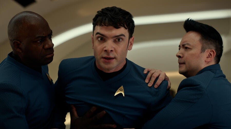 Two science officers hold back an angered human Spock in 'Charades'