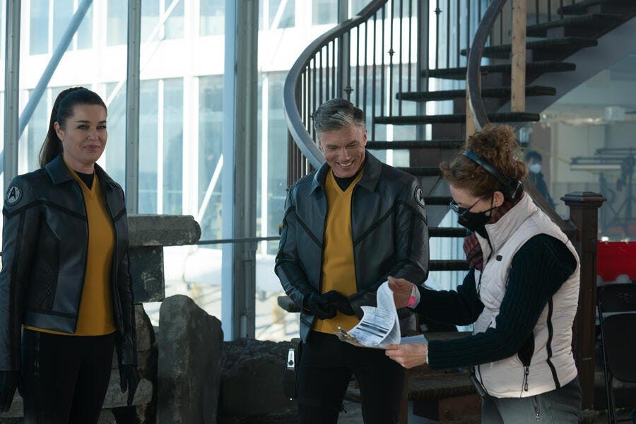 Rebecca Romijn and Anson Mount smile between takes of the episode 