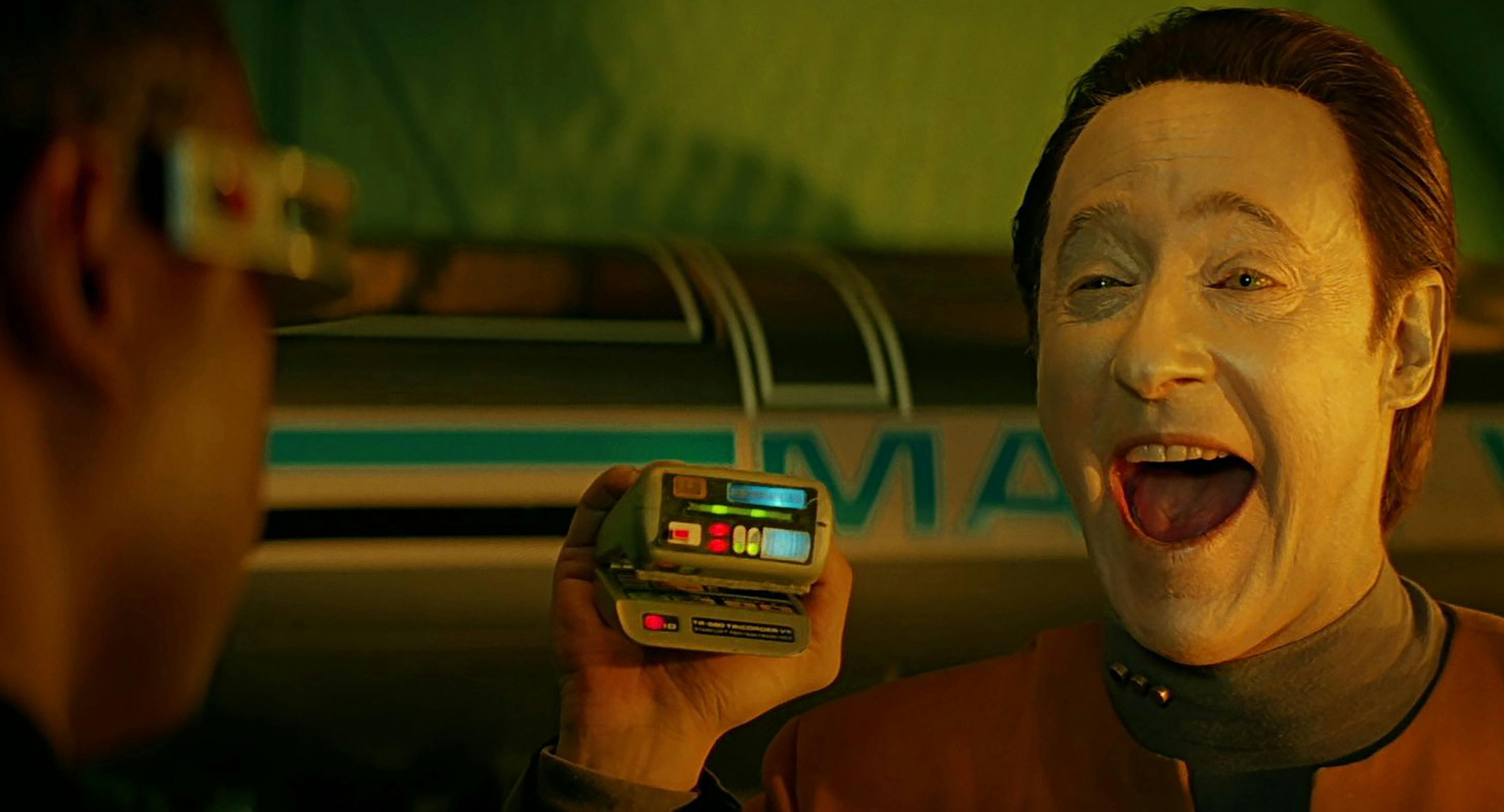 Data open mouth smiles at Geordi La Forge