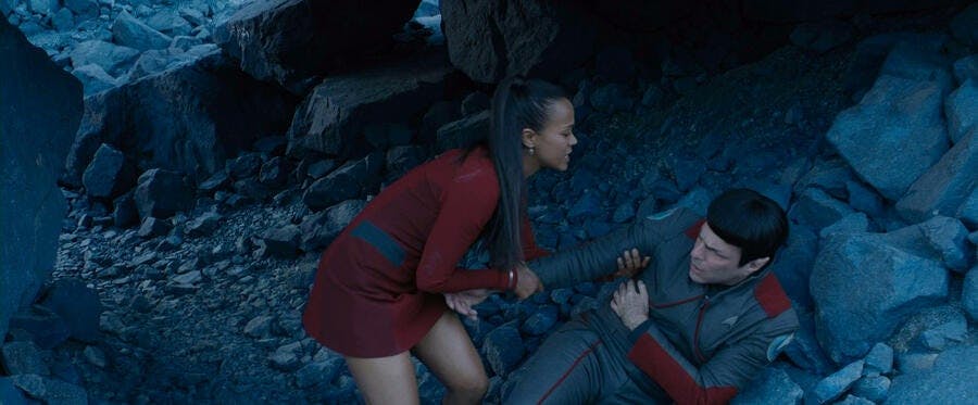 Uhura lifts an injured Spock from the rubble in Star Trek Beyond