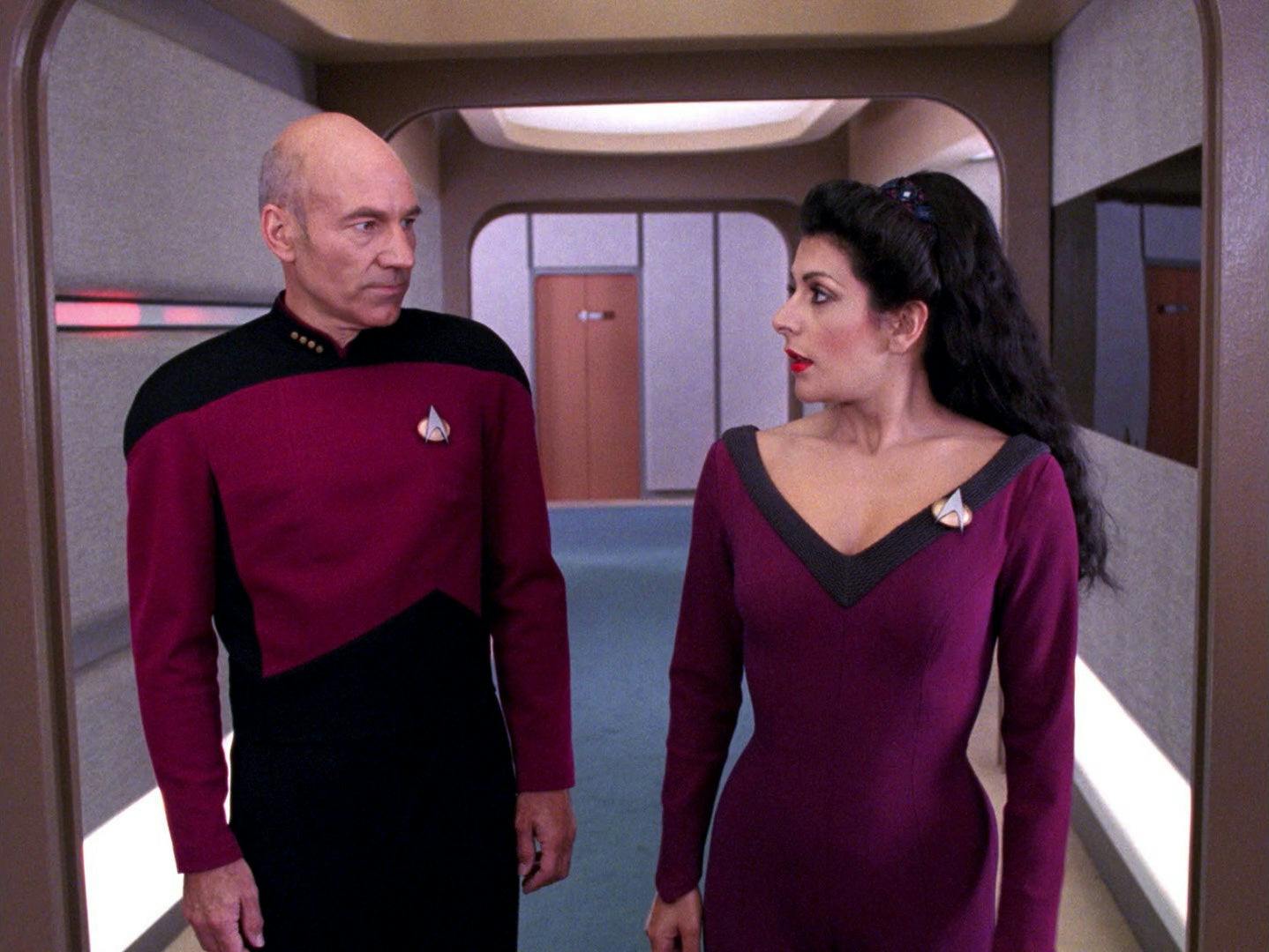 Deanna Troi offers Picard her counsel as they walk down the corridor in 'The Bonding'