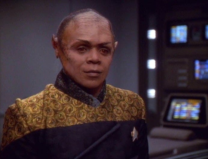 A combination of Tuvok and Neelix, named Tuvix, waits for Janeway's decision.