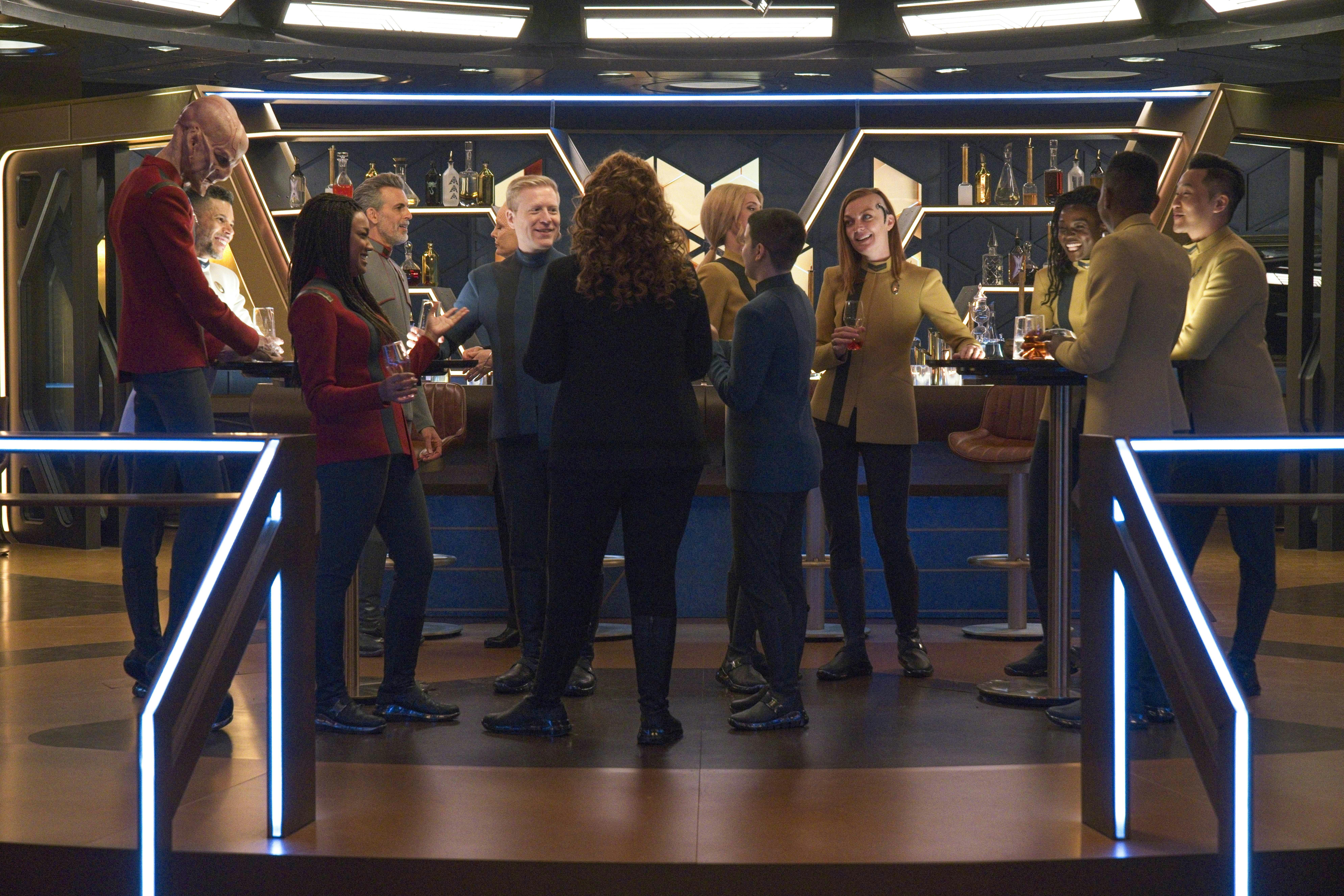 The Discovery crew celebrate crowded around the bar in 'Coming Home'