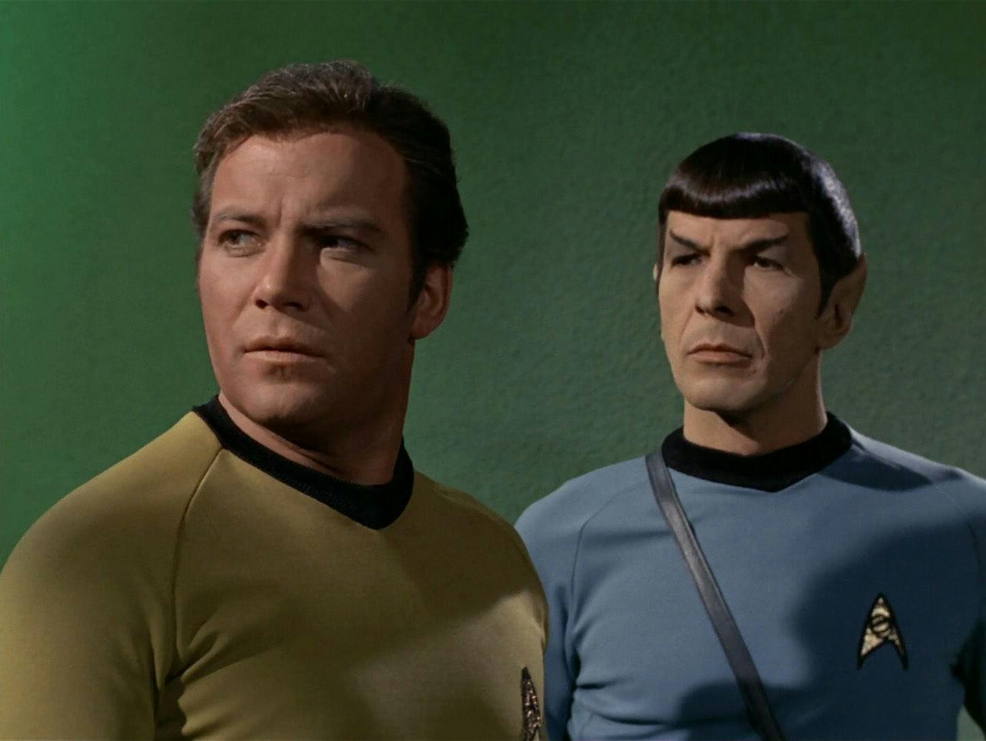 Kirk and Spock stand side-by-side as the captain looks over his shoulder in 'Wink of an Eye'